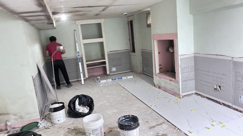 New Jersey basement renovation, replacing drywall with cement‑board and starting new tile flooring installation